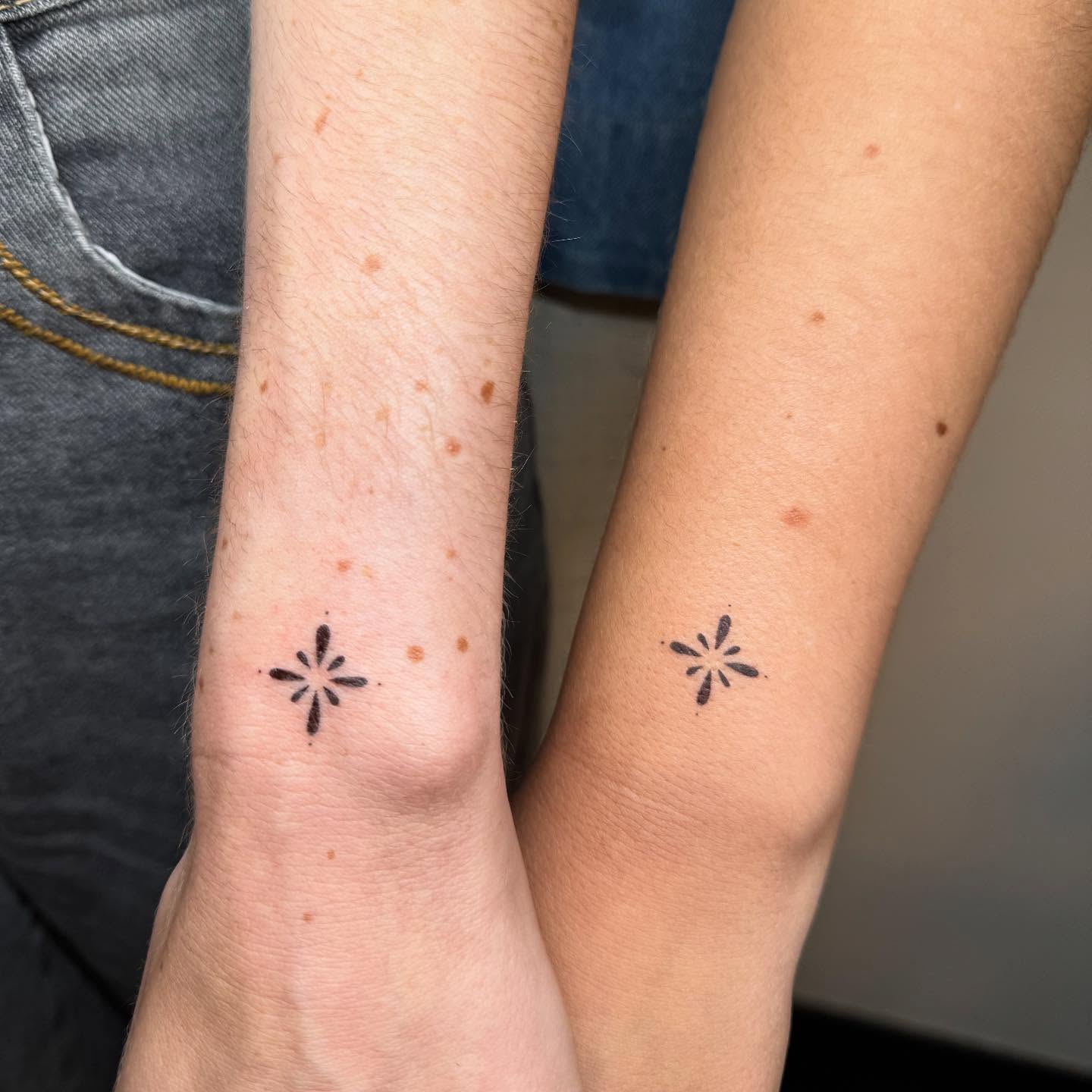 Matching brown-ink ornamental tattoos by Luna Fino